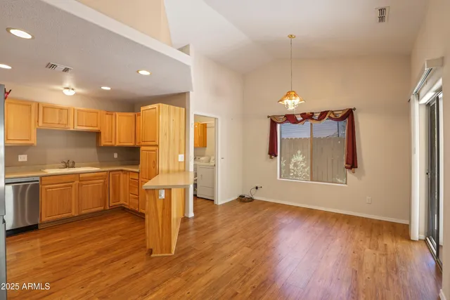 a kitchen with a refrigerator and a stove top oven