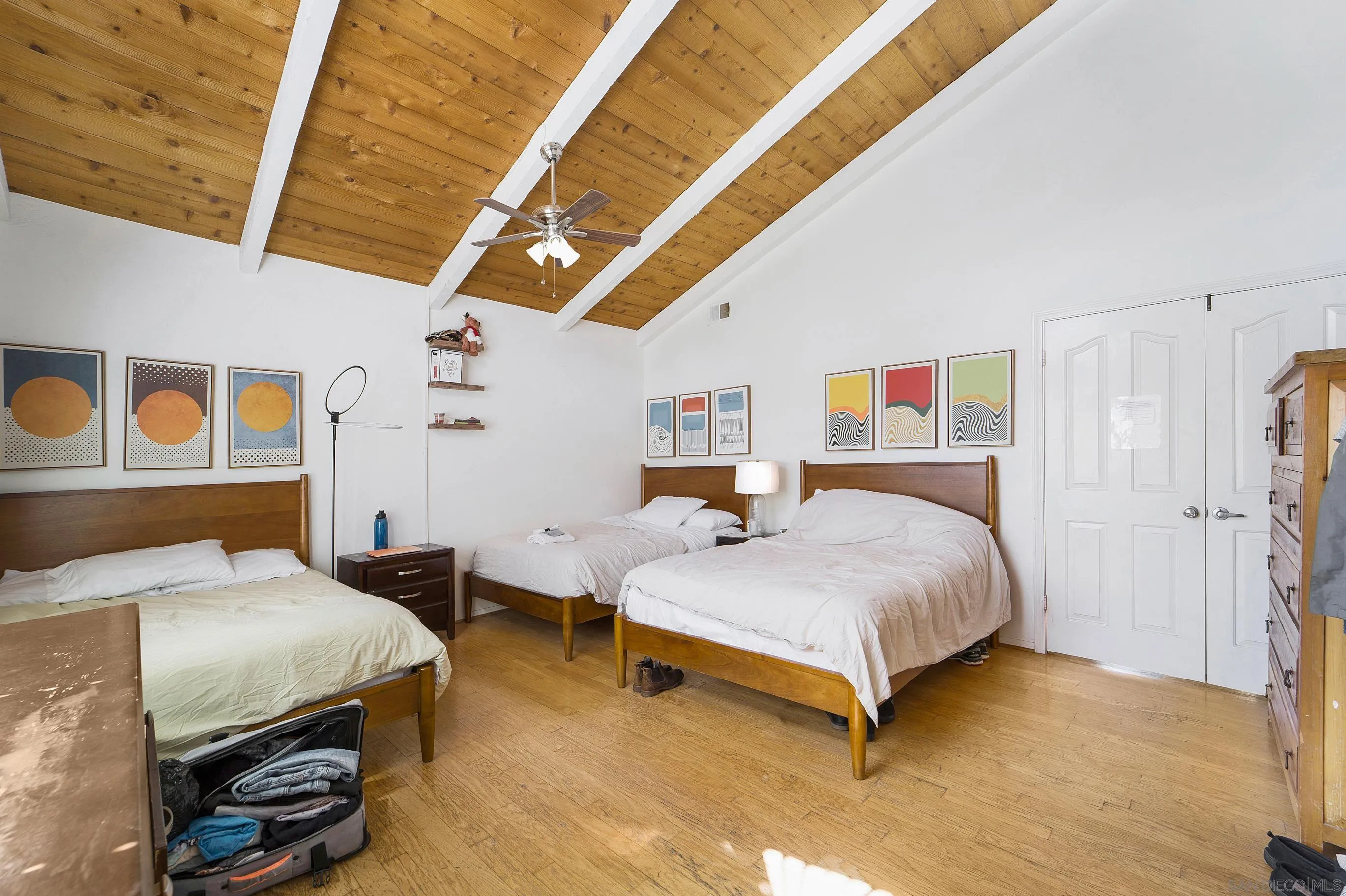 149 Walnut Avenue Carlsbad, CA 92008 - Photo 19 of 48 a bedroom with a bed and wooden floor