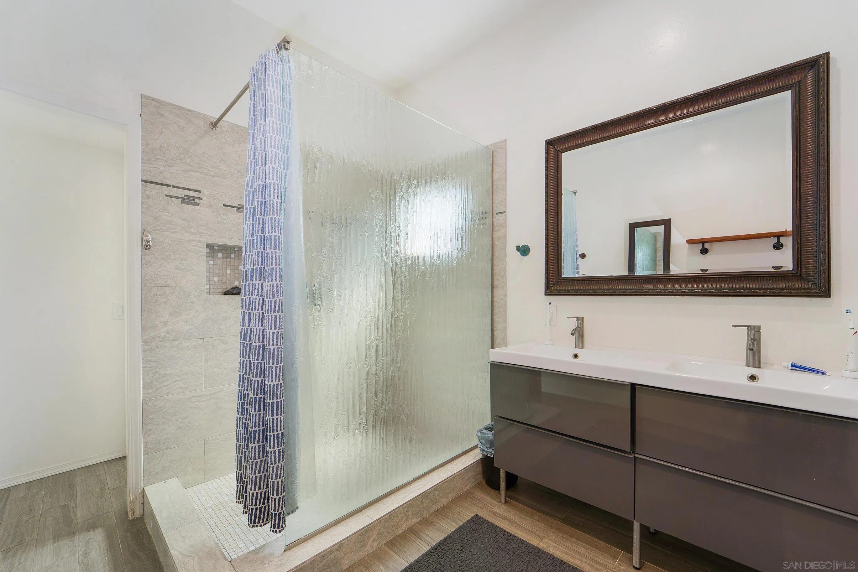 149 Walnut Avenue Carlsbad, CA 92008 - Photo 21 of 48 a bathroom with a shower sink and mirror