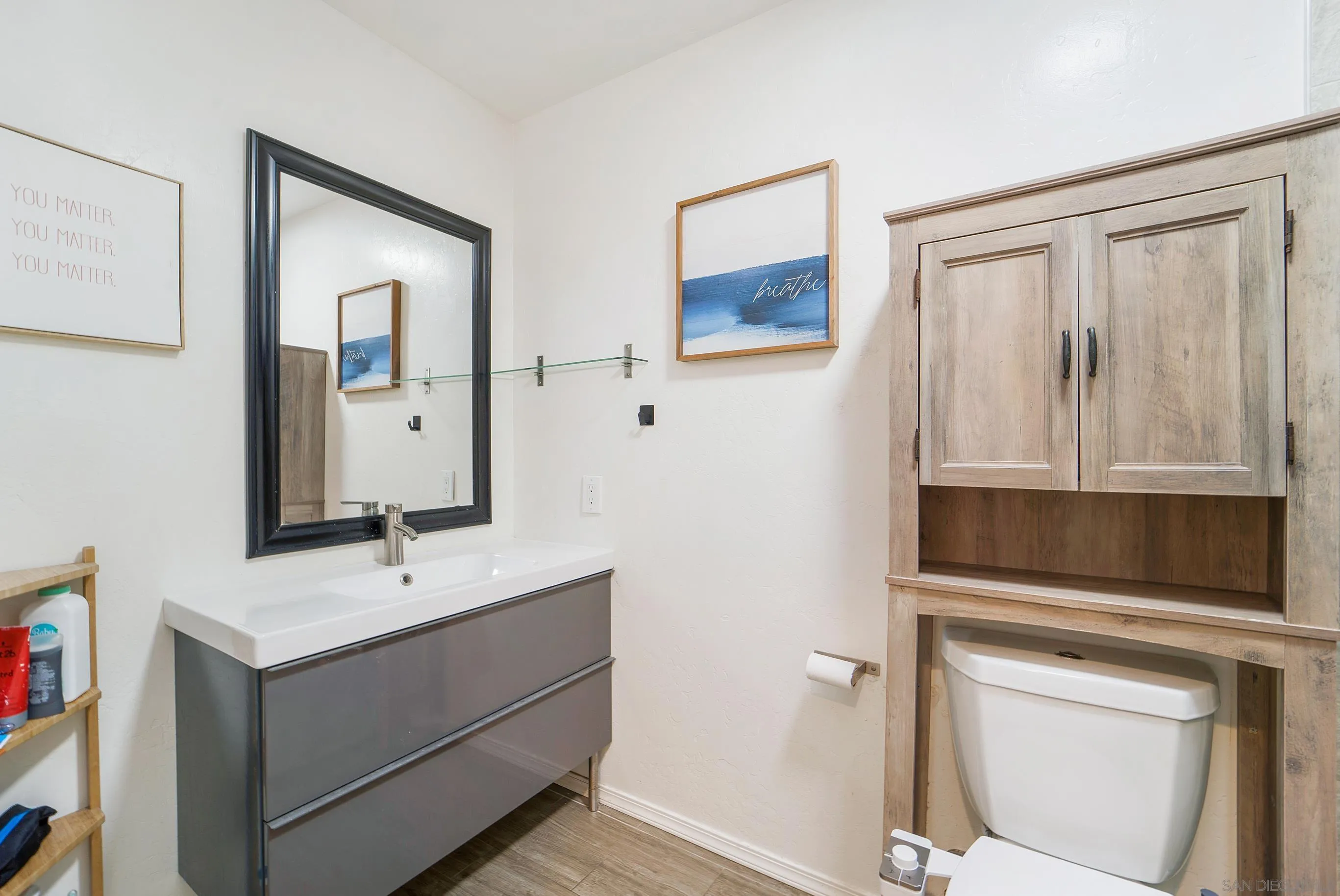 149 Walnut Avenue Carlsbad, CA 92008 - Photo 23 of 48 a bathroom with a sink a toilet and a mirror
