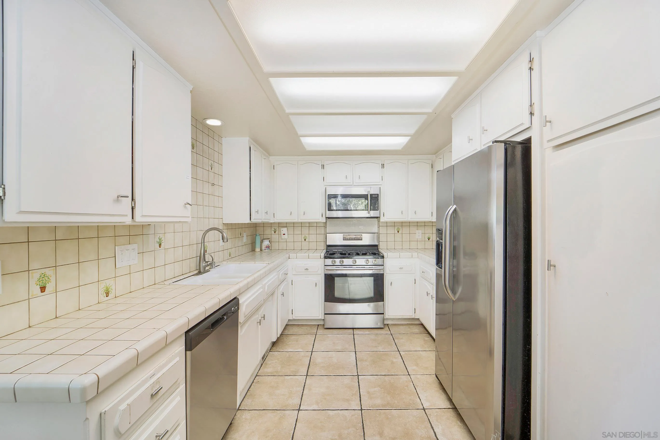 149 Walnut Avenue Carlsbad, CA 92008 - Photo 28 of 48 a kitchen with stainless steel appliances granite countertop a refrigerator and a sink