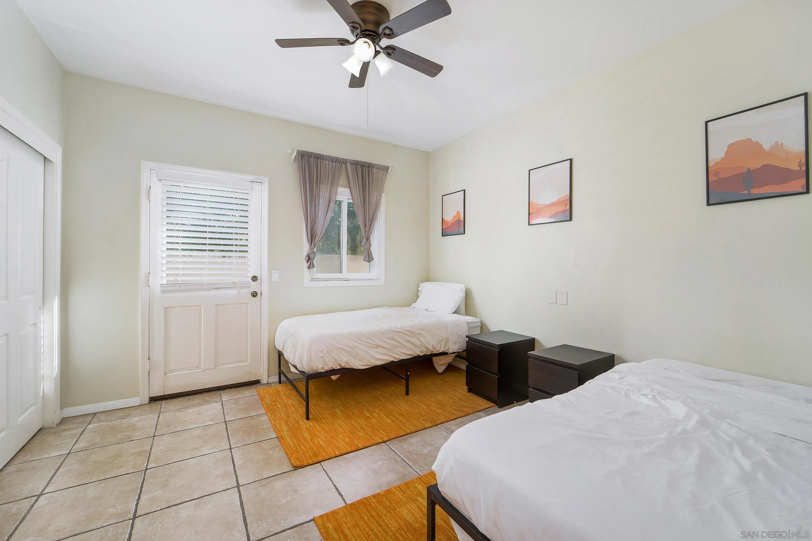 149 Walnut Avenue Carlsbad, CA 92008 - Photo 32 of 48 a bedroom with a bed and a chandelier