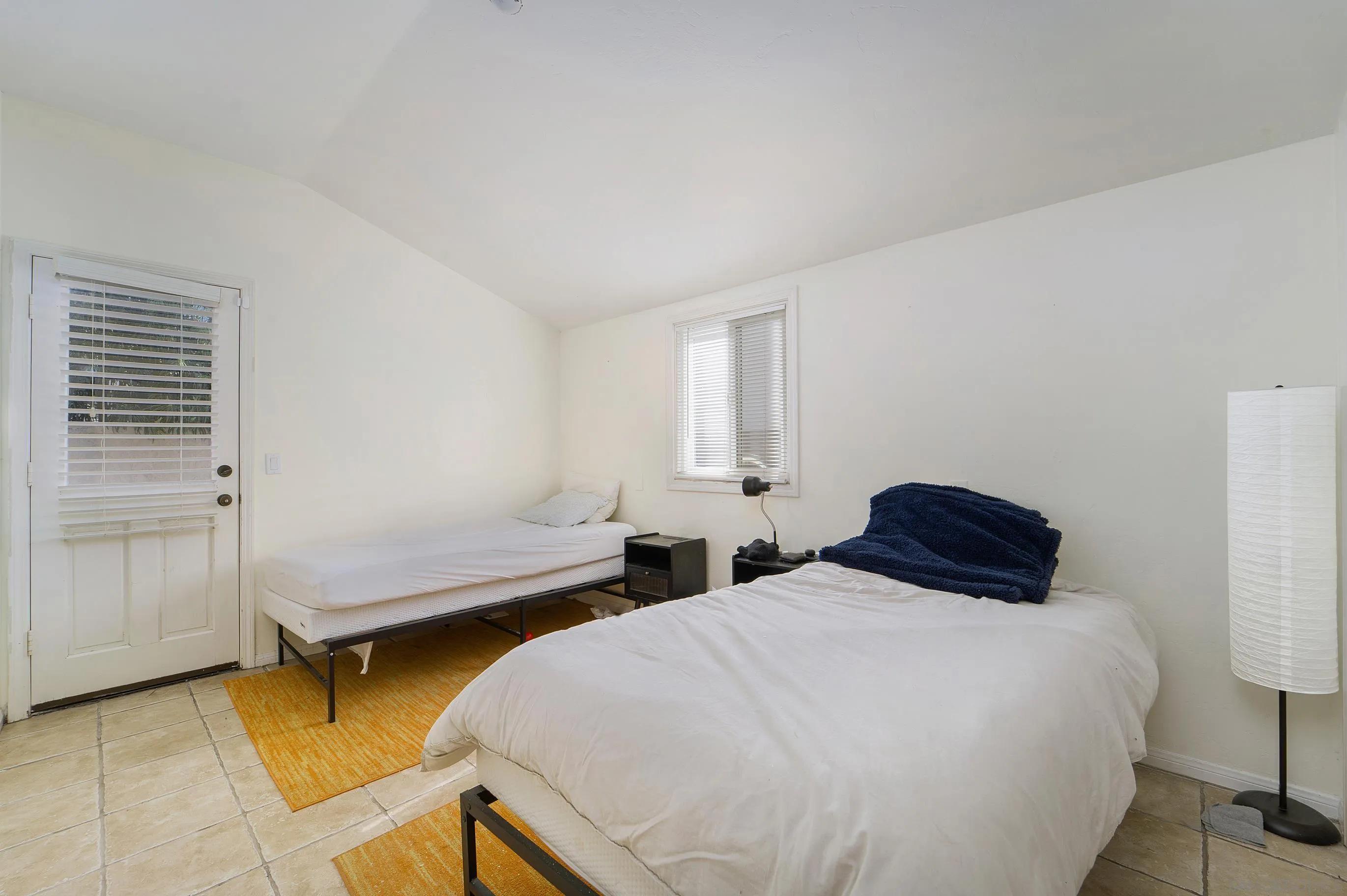149 Walnut Avenue Carlsbad, CA 92008 - Photo 33 of 48 a bedroom with two beds and a lamp on dresser