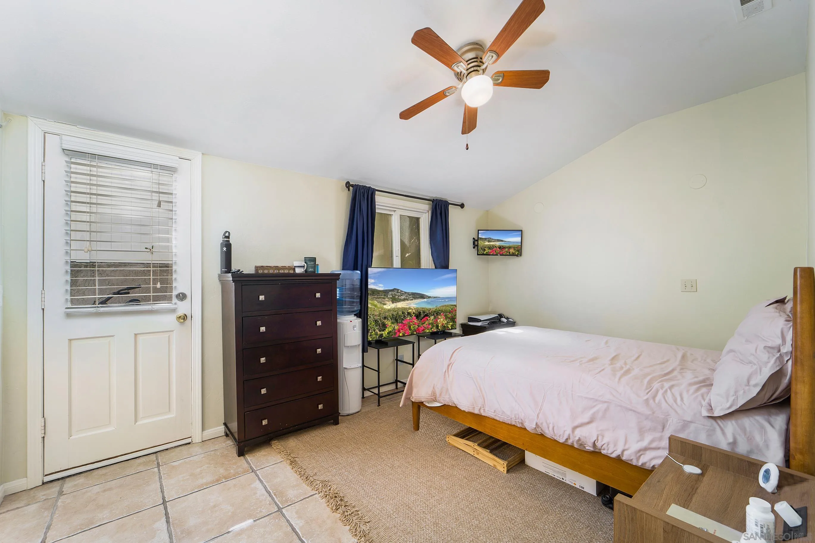 149 Walnut Avenue Carlsbad, CA 92008 - Photo 35 of 48 a bedroom with a bed and a chandelier