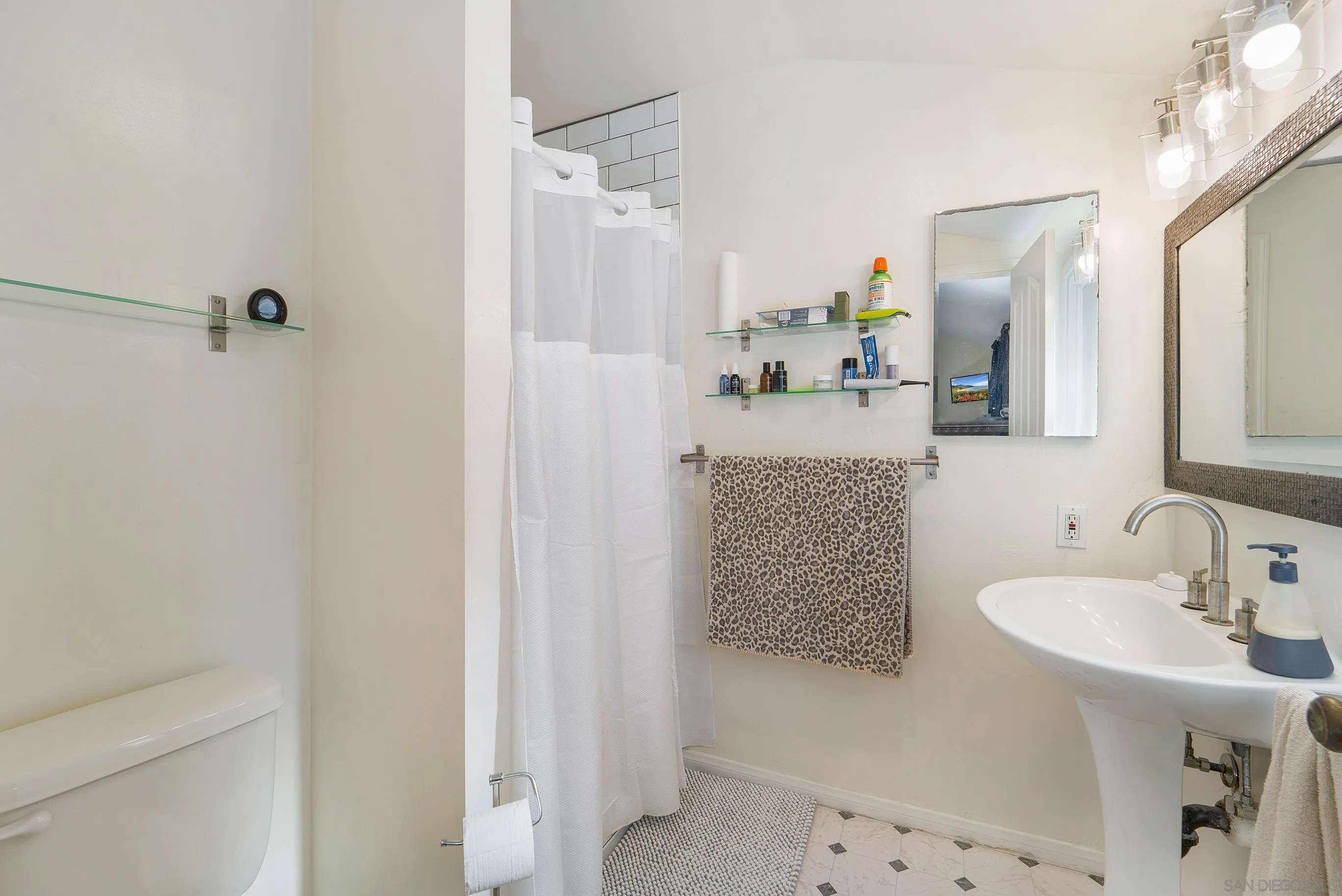 149 Walnut Avenue Carlsbad, CA 92008 - Photo 36 of 48 a bathroom with a granite countertop sink a mirror and shower