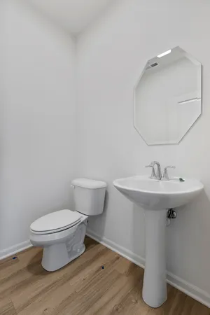 a bathroom with a sink toilet and a mirror
