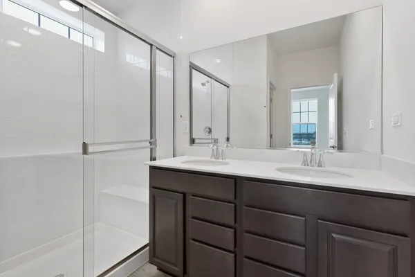 a bathroom with a double vanity sink mirror and double