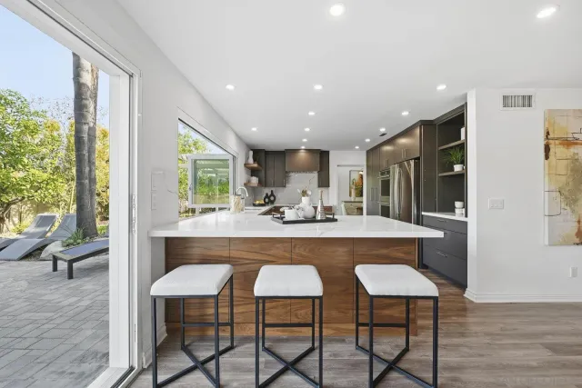 a view of dining table chairs and wooden floor