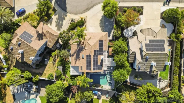an aerial view of residential houses with outdoor space and street view