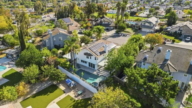 an aerial view of multiple houses with yard