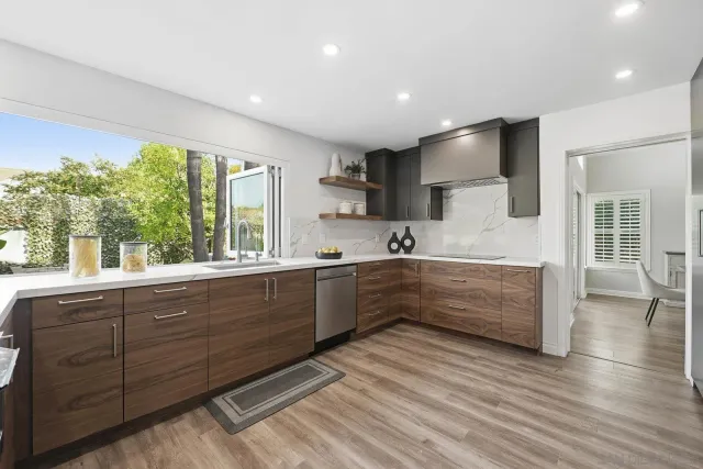 a kitchen with stainless steel appliances kitchen island wooden cabinets and granite counter tops