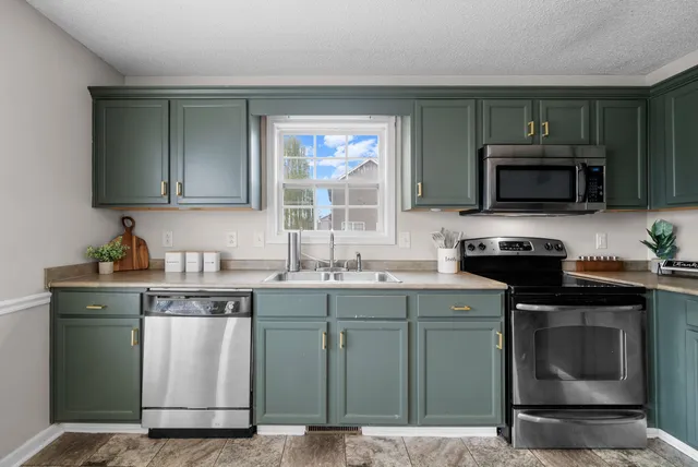 a kitchen with a sink and a microwave