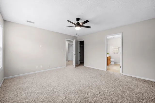 a view of an empty room with a ceiling fan