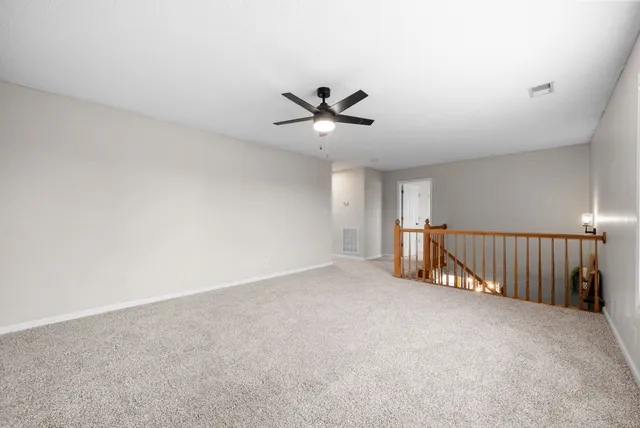 a view of a livingroom with a ceiling fan and window