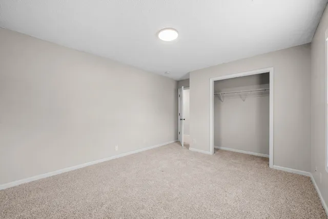 a view of an empty room and closet area