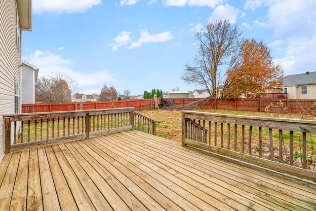 a view of a wooden deck with a yard