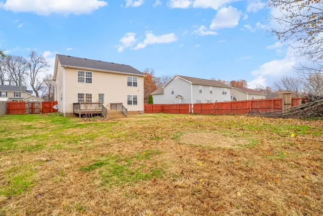 a view of a house with a yard and sitting area