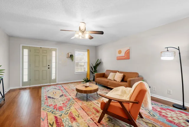 a living room with furniture and wooden floor