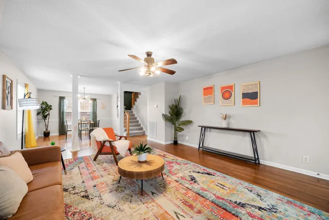 a living room with furniture and wooden floor