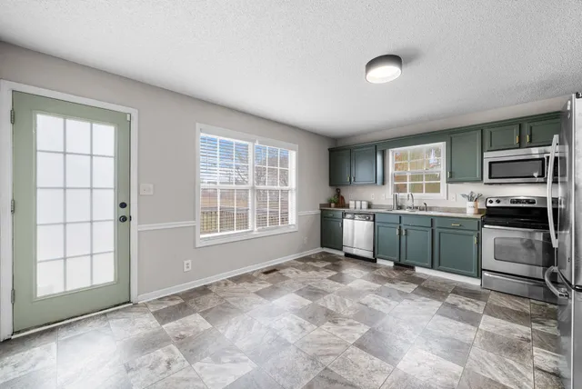 a kitchen with a stove a sink and a refrigerator