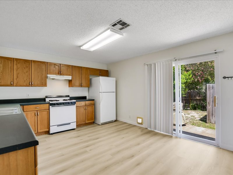13827 Spring Heath Road Pflugerville, TX 78660 - Photo 11 of 20 A functional kitchen space flows seamlessly to a private yard through sliding glass doors.