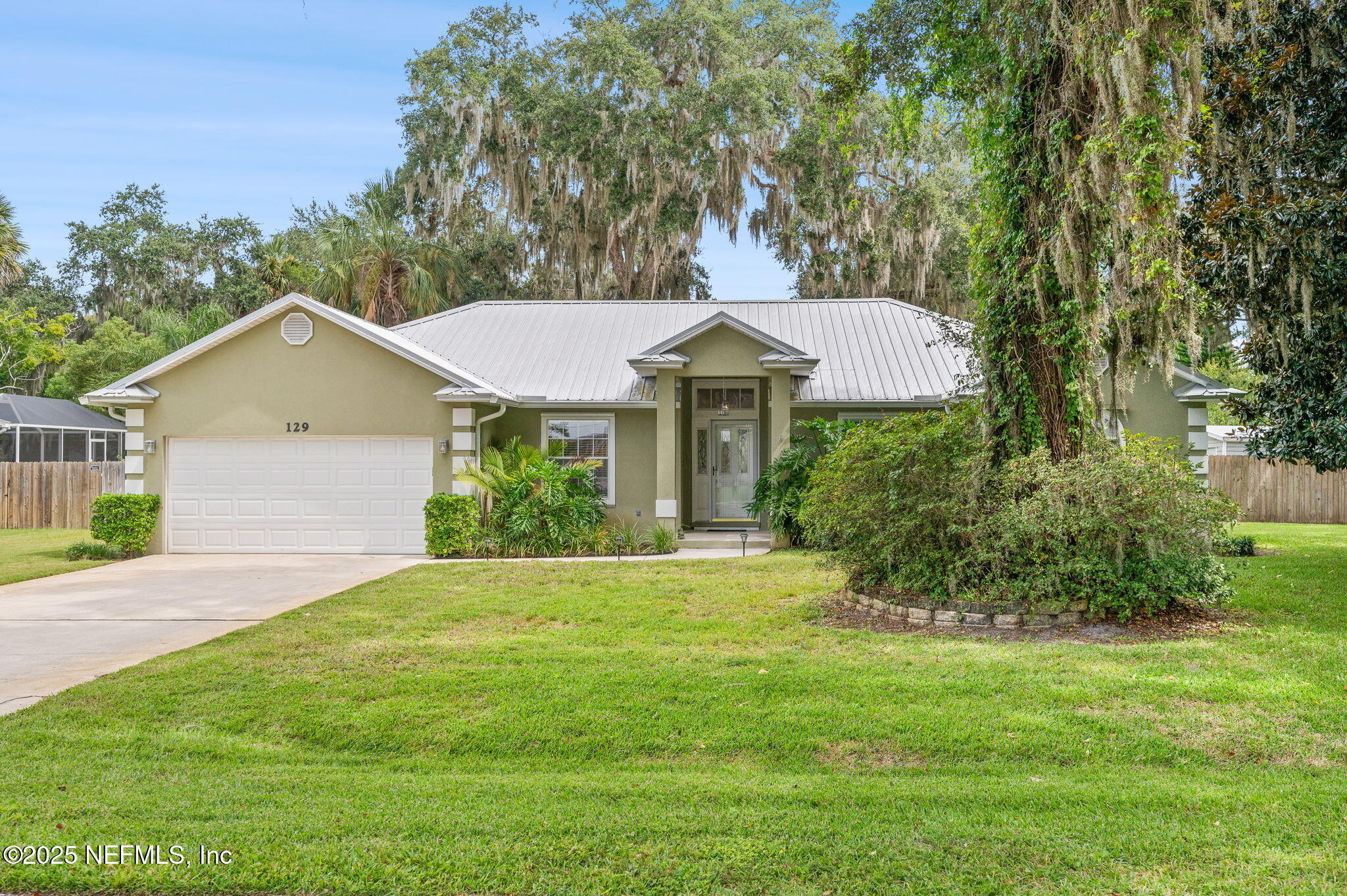 129 Linden Road St. Augustine, FL 32086 - Photo 1 of 56 a front view of a house with a yard and trees