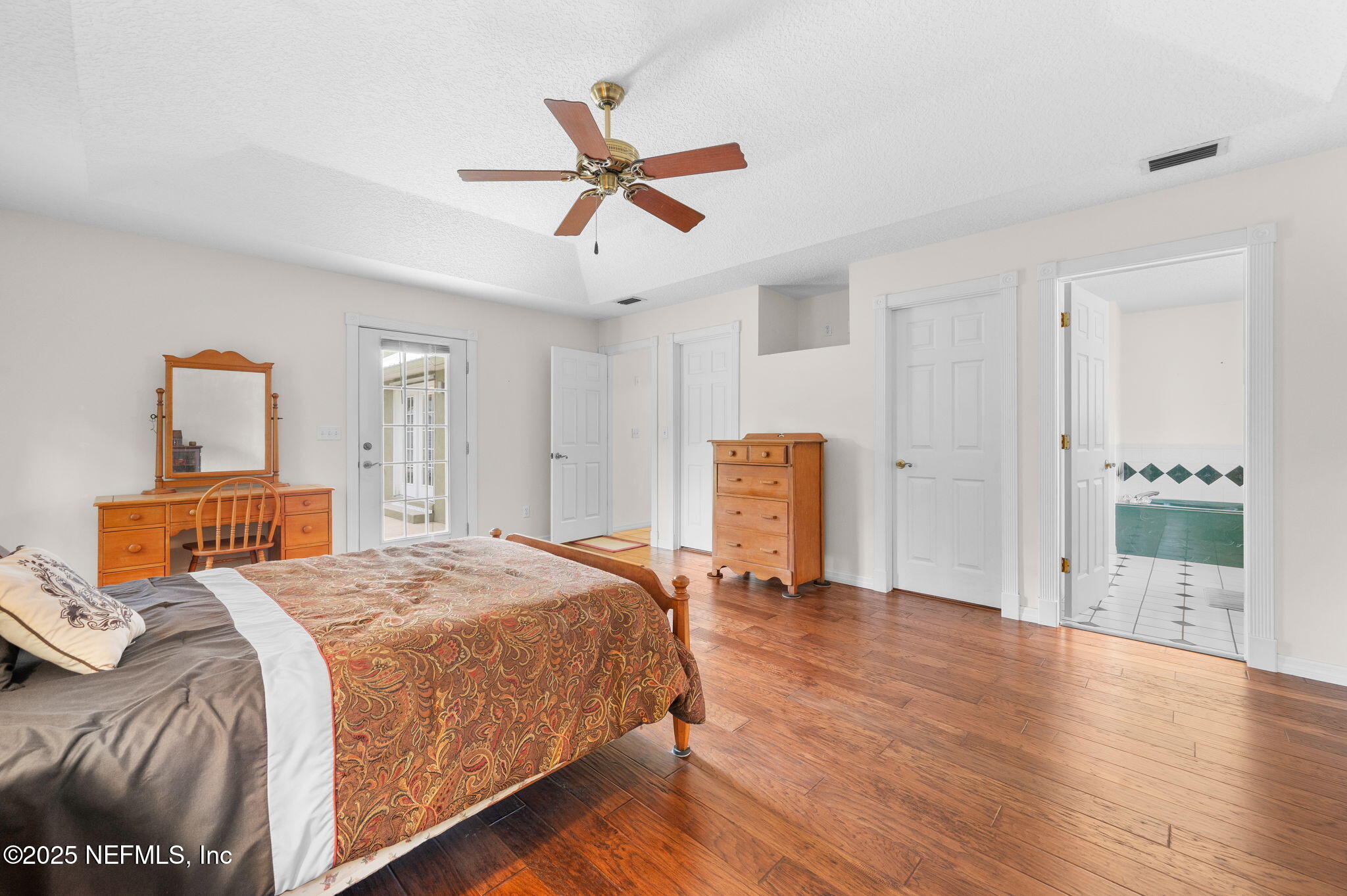 129 Linden Road St. Augustine, FL 32086 - Photo 26 of 56 a bedroom with a bed and a chandelier
