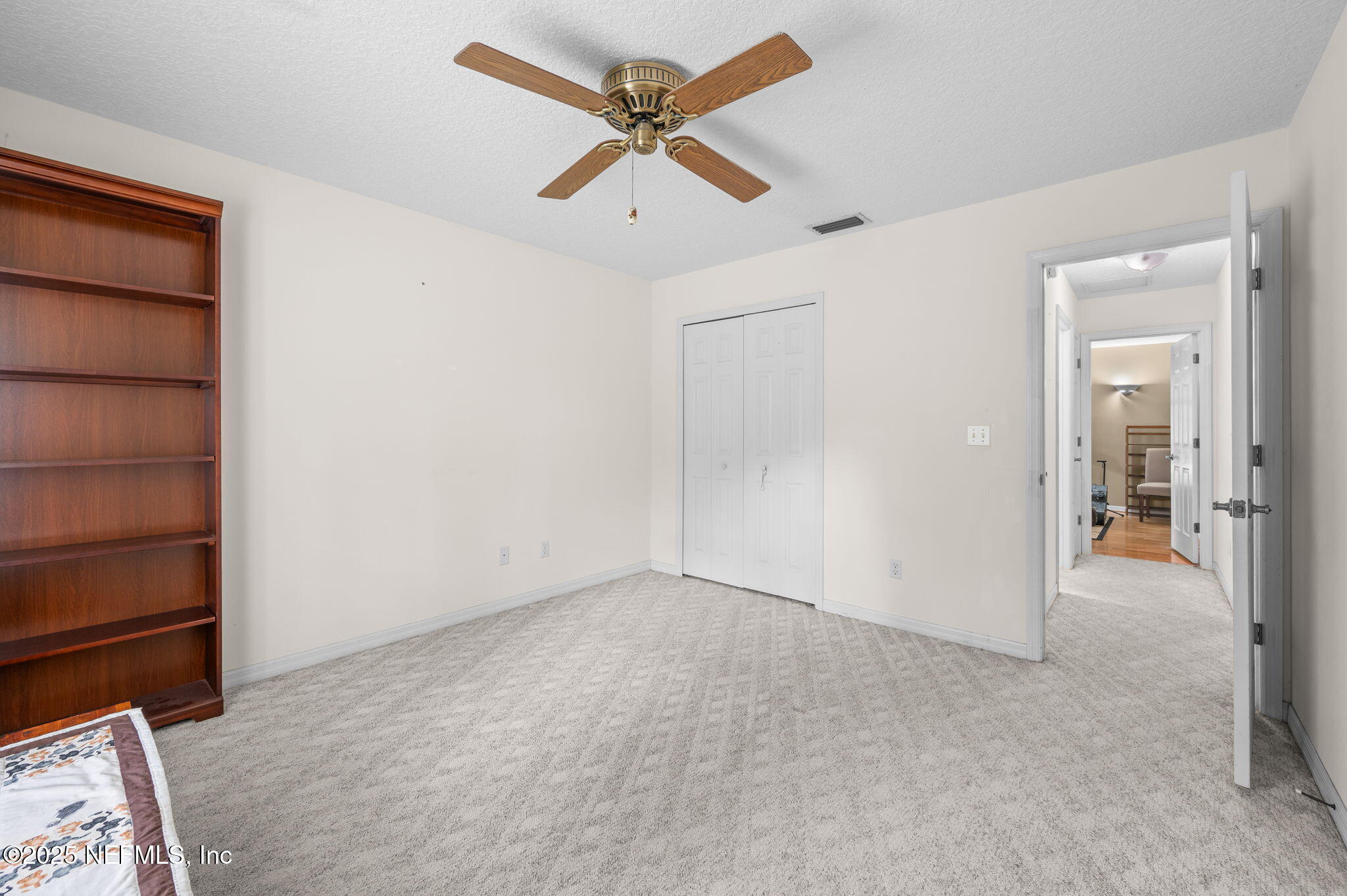 129 Linden Road St. Augustine, FL 32086 - Photo 29 of 56 an empty room with closet and a ceiling fan