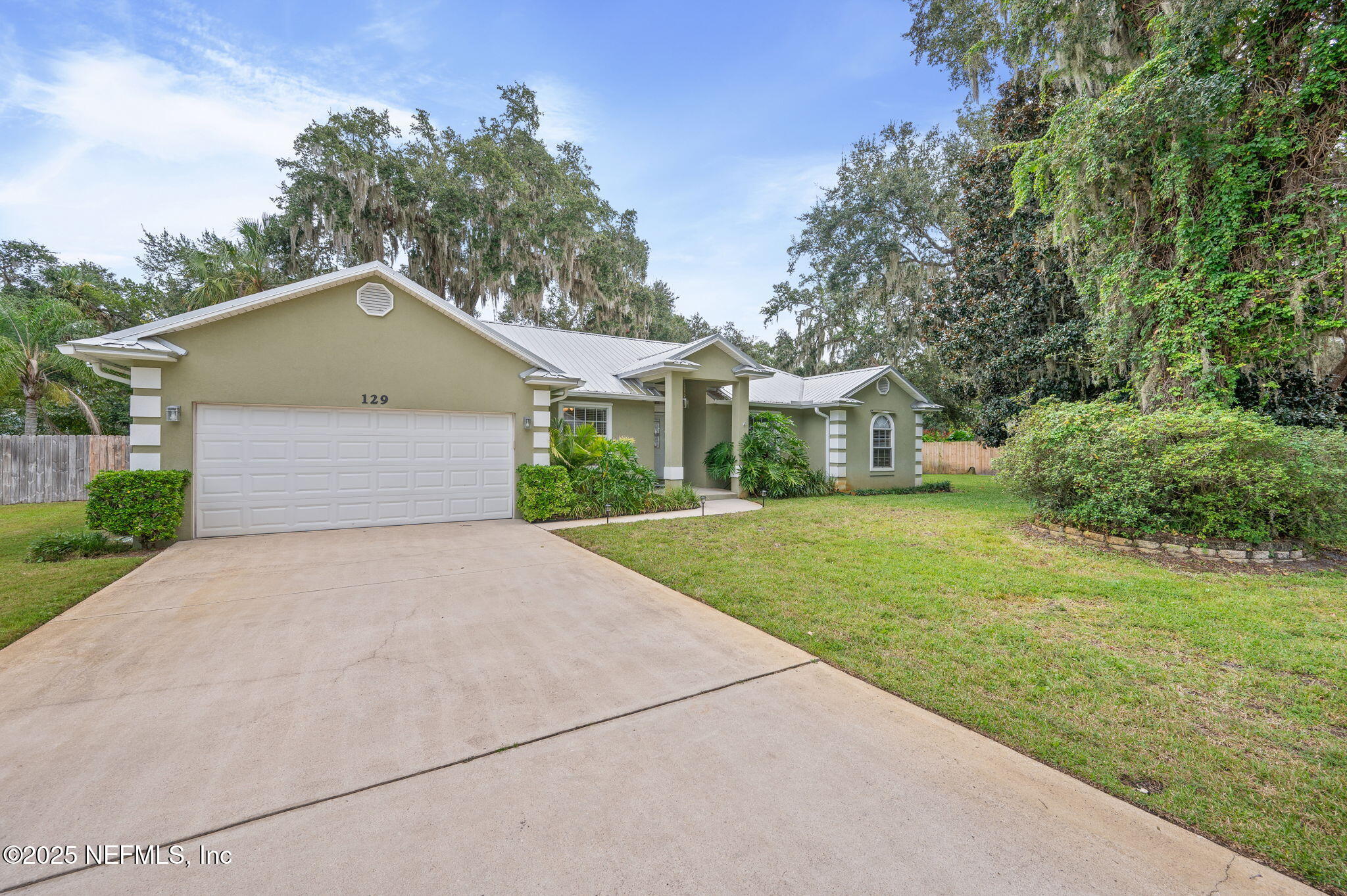129 Linden Road St. Augustine, FL 32086 - Photo 5 of 56 a front view of a house with a yard and trees