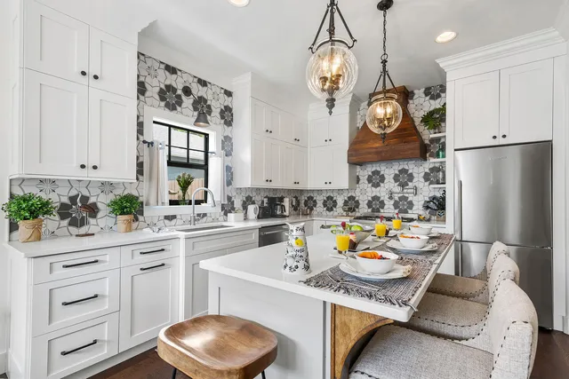 a kitchen with a white cabinets and chairs