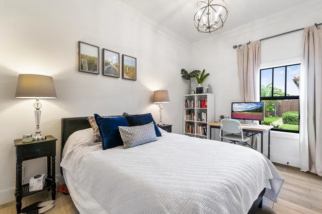 a bedroom with a bed and a chair