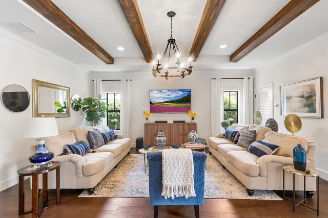 a living room with furniture chandelier and a chandelier