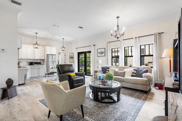a living room with furniture fireplace and a chandelier