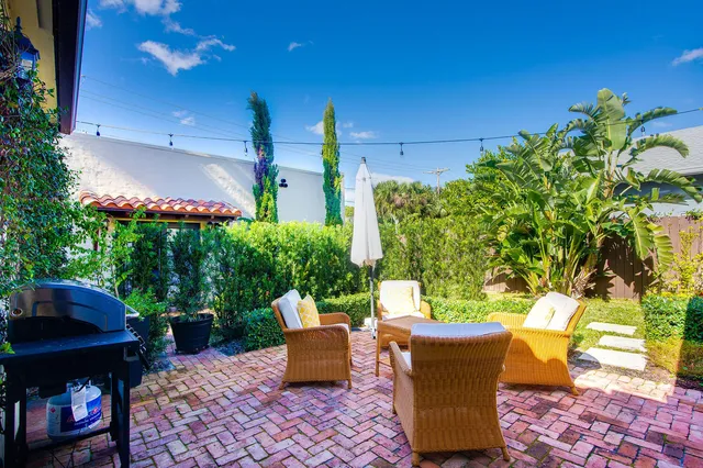 a view of a patio with table and chairs and potted plants