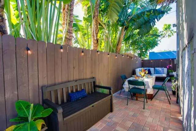 a view of a backyard with a tub and outdoor seating