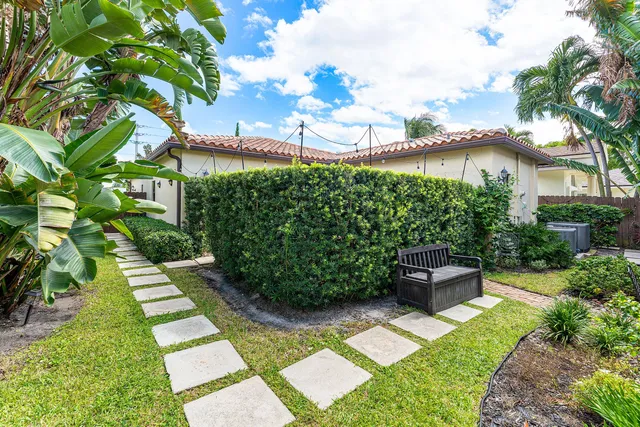 a front view of a house with a garden