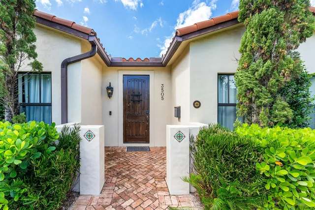 a front view of a house with garden