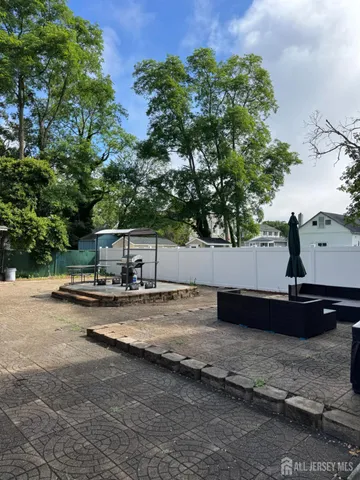 a view of a lake with a large tree