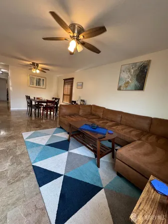 a living room with a rug and a table