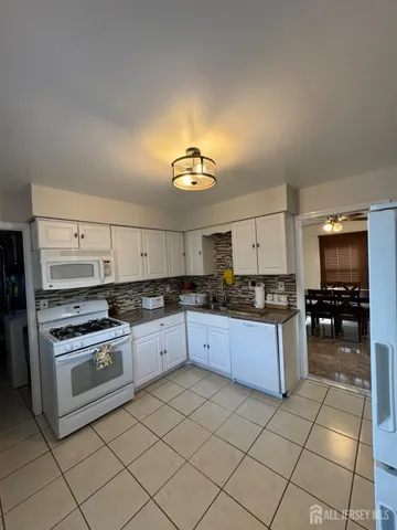 a kitchen with a stove a sink and a refrigerator