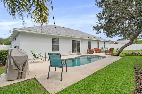 a view of a backyard with a patio and a garden