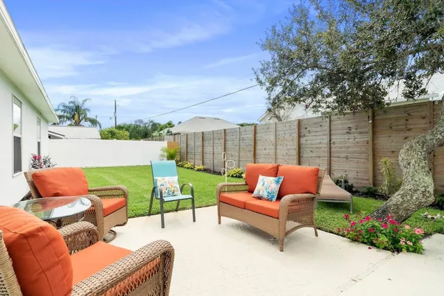 a backyard of a house with outdoor seating