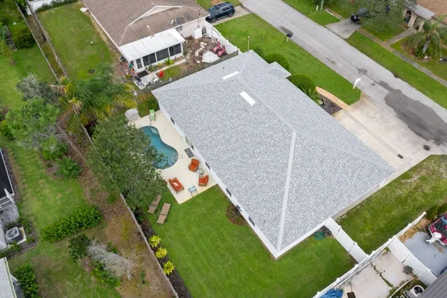 an aerial view of a house with a garden and trees