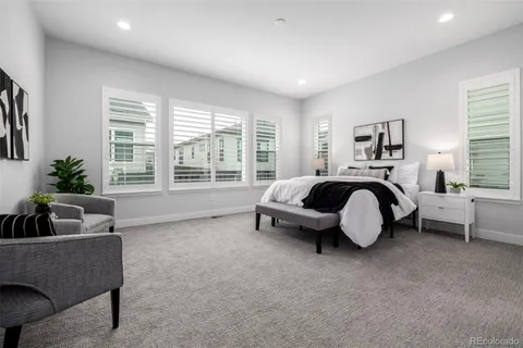 a spacious bedroom with a bed and a couch