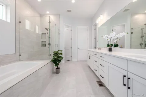 a bathroom with a shower sink vanity and mirror