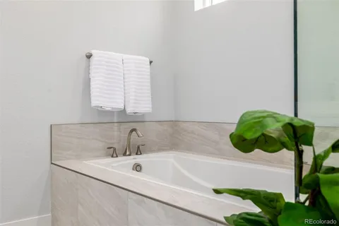a bedroom with a bed and a potted plant