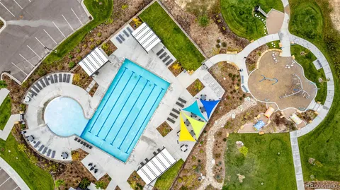 an aerial view of a house with swimming pool and mountain view