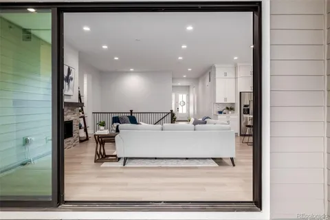 a large white building with glass top table and chairs