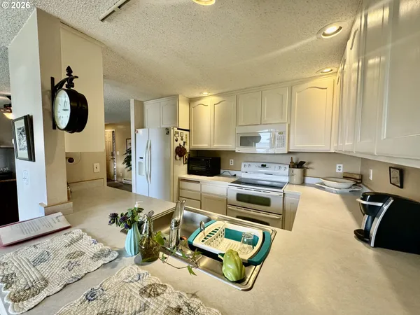 a kitchen with a refrigerator and a stove top oven