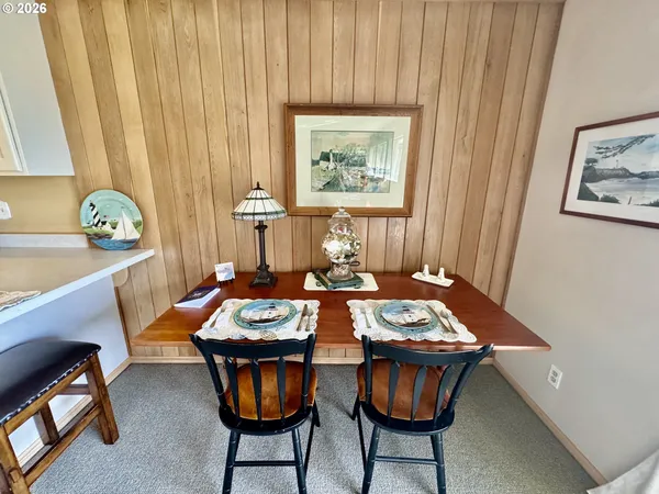a view of a dining room with furniture and window